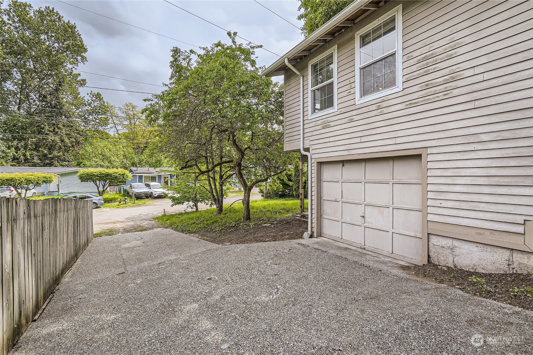 6935 24th Avenue Southwest Seattle, WA 98106 - Photo 27 of 27 a view of a house with a yard and garage