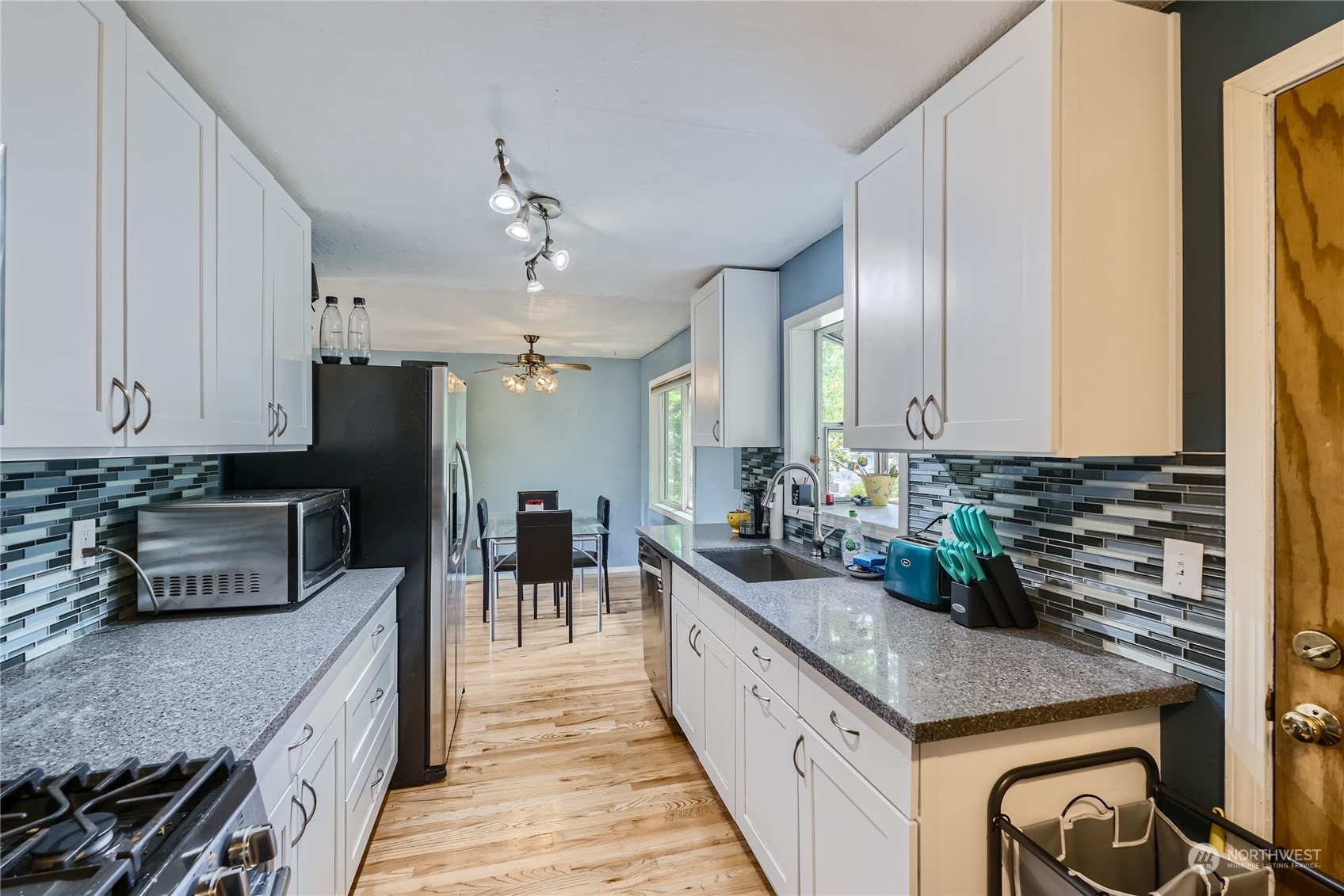 6935 24th Avenue Southwest Seattle, WA 98106 - Photo 9 of 27 a kitchen with lots of counter top space and stainless steel appliances
