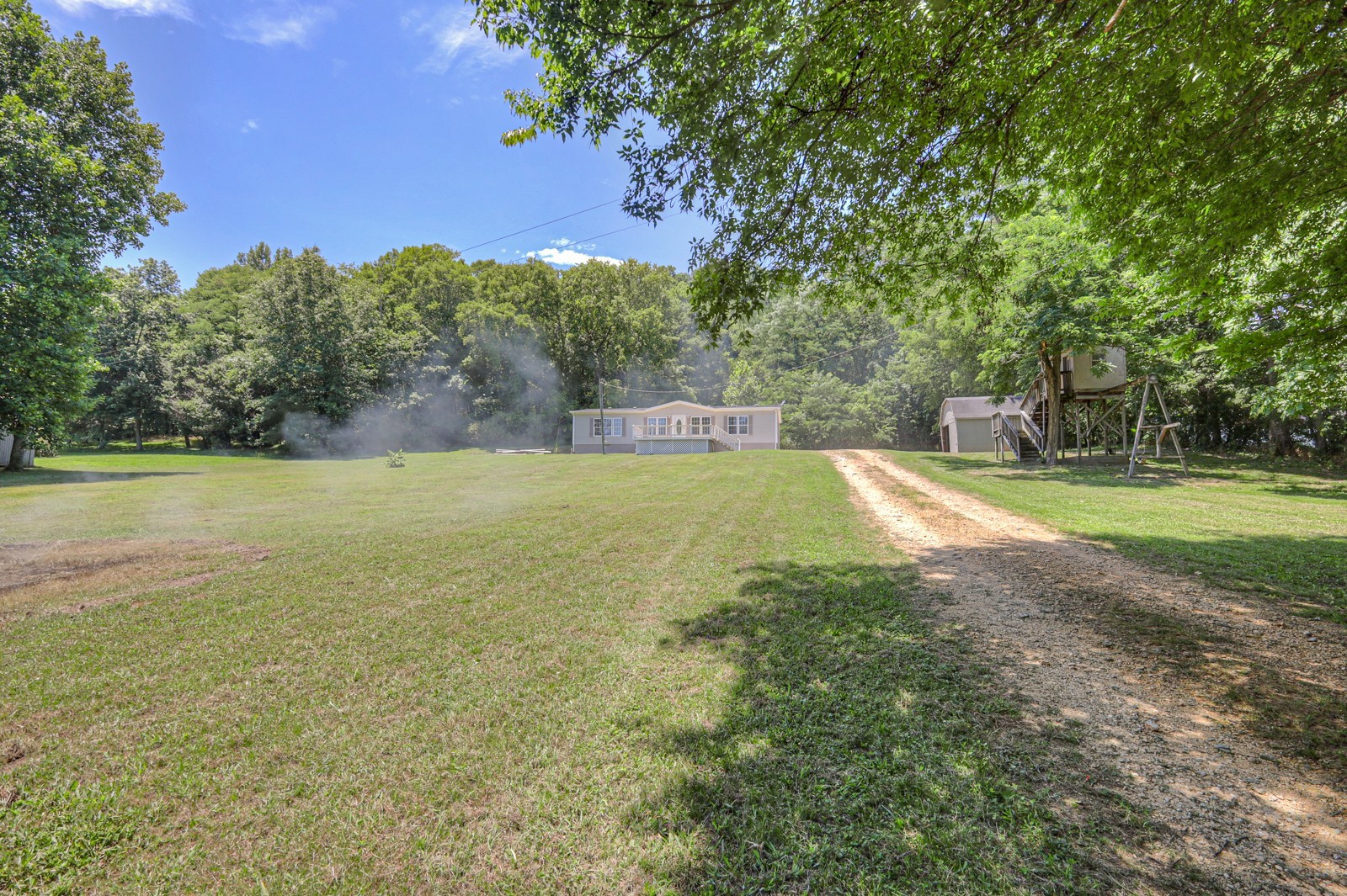 4002 Rippey Lake Road Mount Pleasant, TN 38474 - Photo 33 of 43 a view of a swimming pool and trees in the background