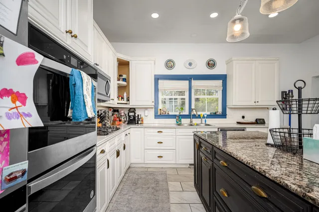 a bedroom with a bed and a flat tv screen on dresser