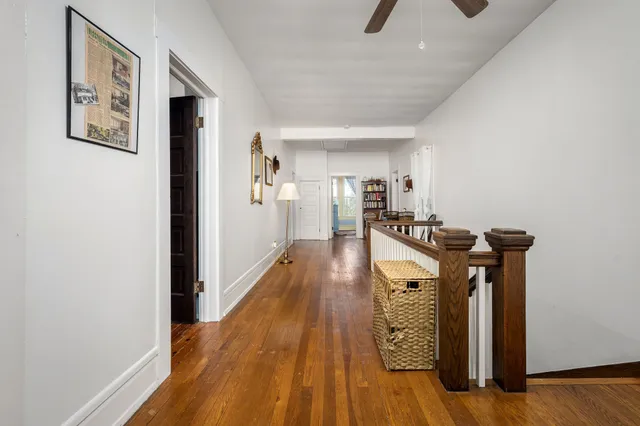 a view of a room with furniture and wooden floor