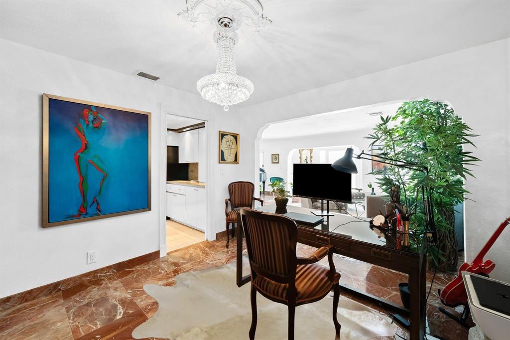 3301 Northeast 27th Avenue Lighthouse Point, FL 33064 - Photo 15 of 41 a workspace with furniture and a chandelier