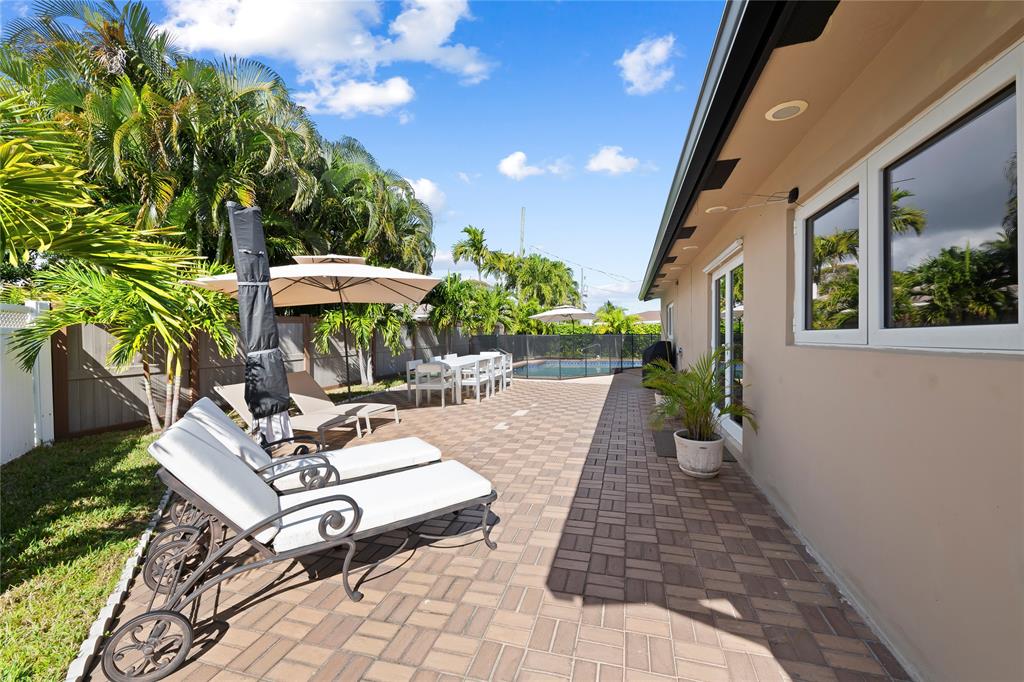 3301 Northeast 27th Avenue Lighthouse Point, FL 33064 - Photo 36 of 41 a view of a patio with chairs and potted plants