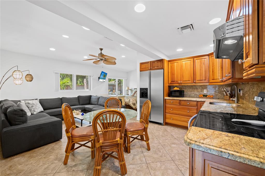 3301 Northeast 27th Avenue Lighthouse Point, FL 33064 - Photo 38 of 41 a dining room with a couch and a stove top oven