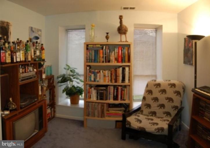3230 Spartan Road, Unit 67 Olney, MD 20832 - Photo 9 of 11 a living room with furniture cabinets and a flat screen tv