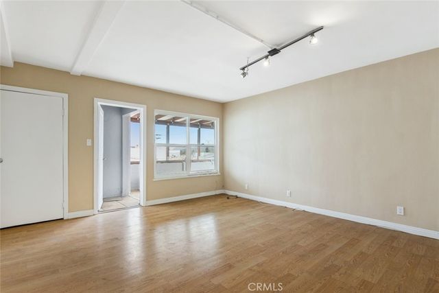 a view of a room with wooden floor and windows