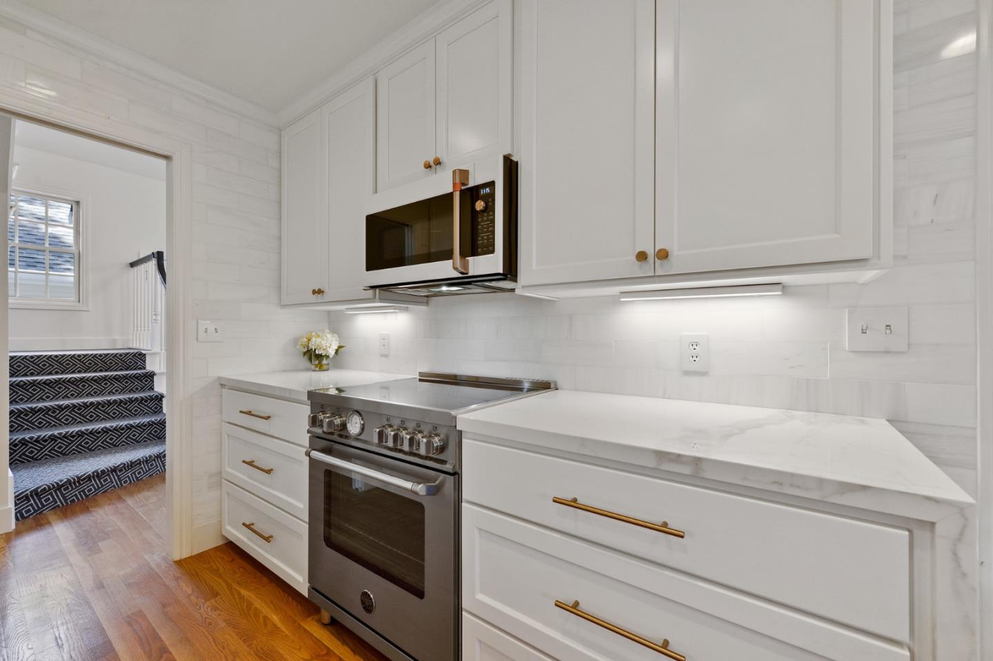751 Partridge Avenue Menlo Park, CA 94025 - Photo 13 of 37 a kitchen with white cabinets and appliances