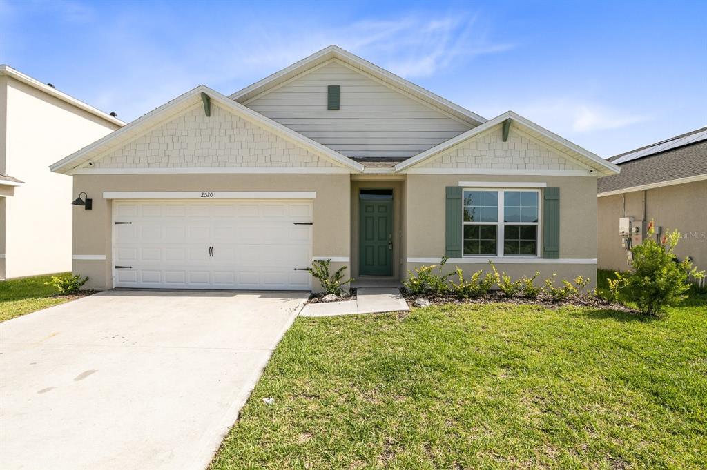 a front view of a house with a yard
