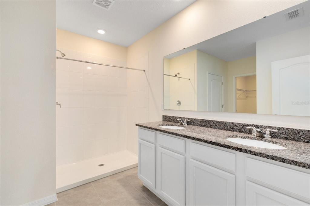 2520 Harmonia Hammock Road Harmony, FL 34773 - Photo 15 of 26 a bathroom with a granite countertop sink and a mirror