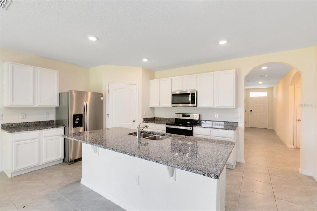 2520 Harmonia Hammock Road Harmony, FL 34773 - Photo 2 of 26 a kitchen with stainless steel appliances granite countertop a sink refrigerator and microwave