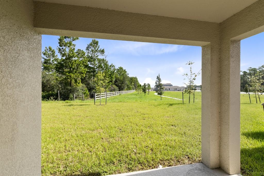 2520 Harmonia Hammock Road Harmony, FL 34773 - Photo 21 of 26 a view of a swimming pool with an outdoor space and seating area