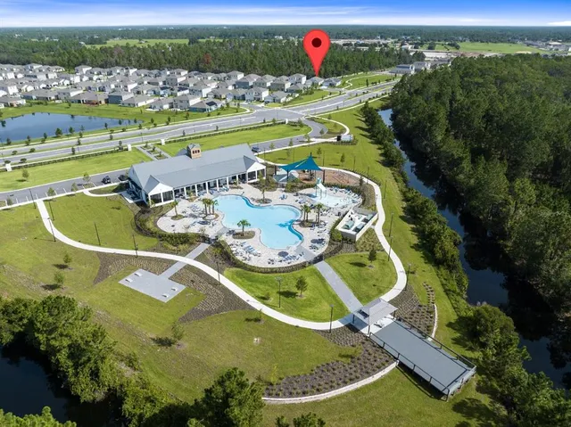 an aerial view of a swimming pool with a yard