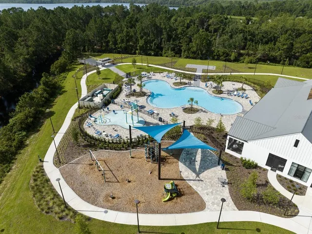 an aerial view of a house with a garden and pool