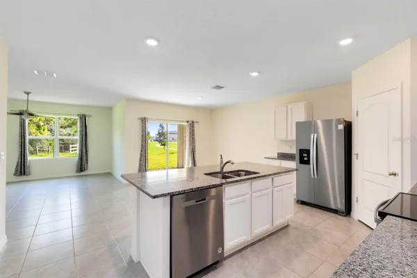 a kitchen with refrigerator and window