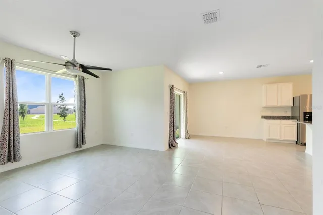 a view of a hallway with toilet and a bathroom