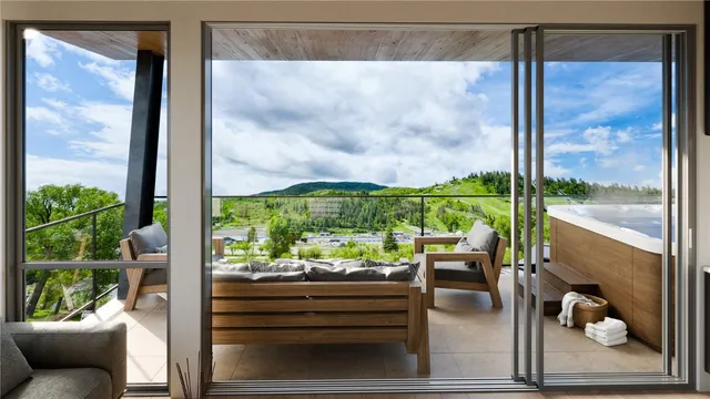 a living room filled with furniture and a floor to ceiling window