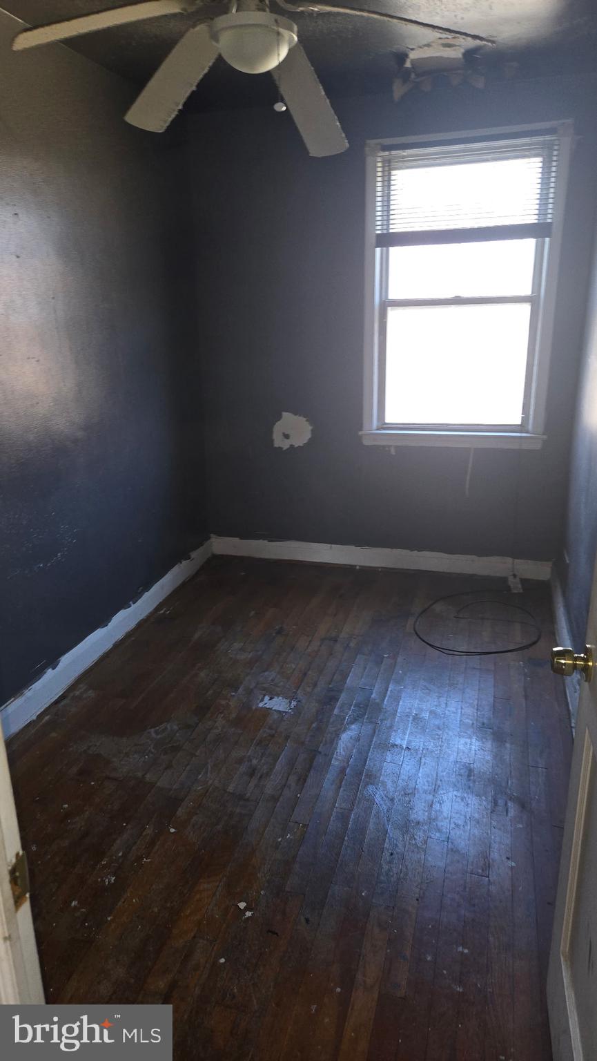 3706 Springwood Avenue Baltimore, MD 21206 - Photo 7 of 12 an empty room with wooden floor and windows
