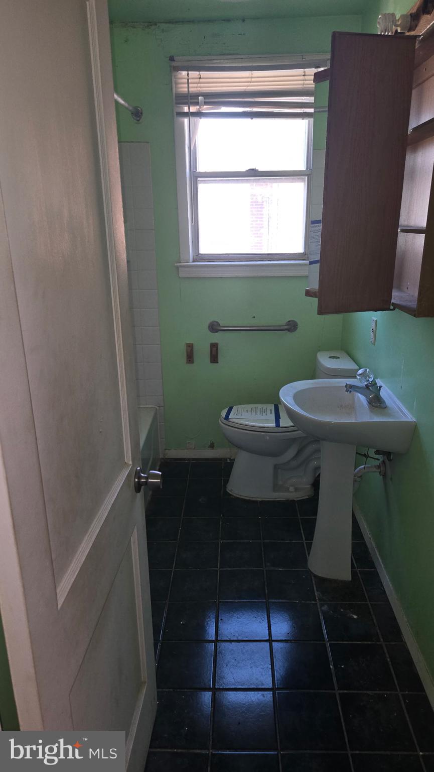 3706 Springwood Avenue Baltimore, MD 21206 - Photo 9 of 12 a bathroom with a sink a toilet and a mirror