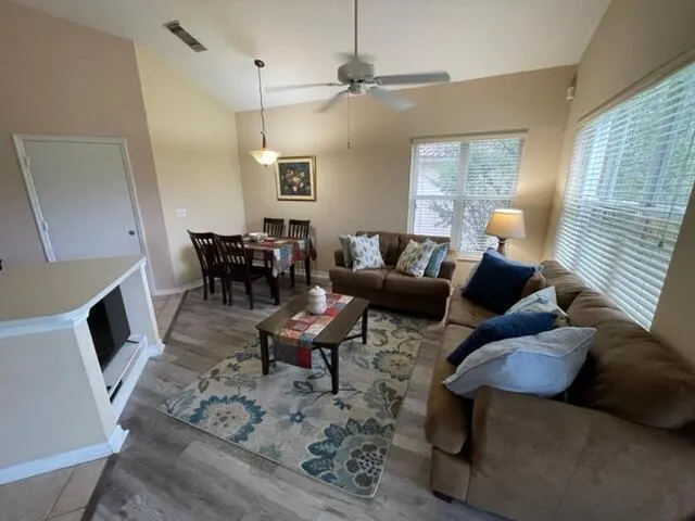 a living room with furniture and wooden floor