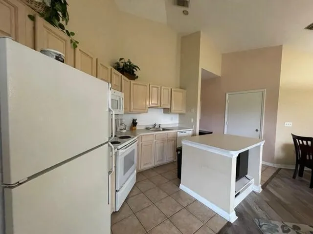 a kitchen with a stove a refrigerator and a sink