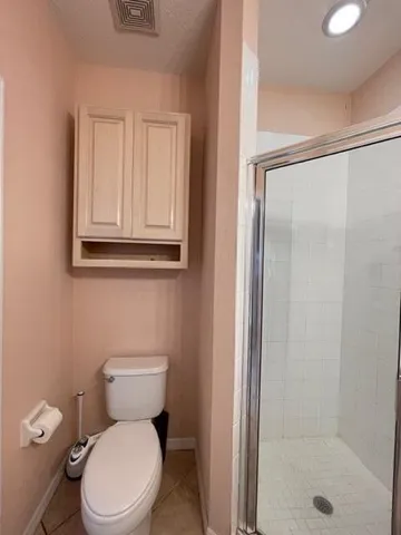 a white toilet sitting next to a bathroom sink