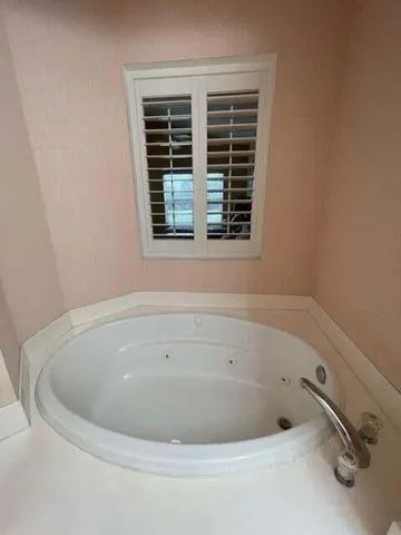 a white bath tub sitting in a bathroom