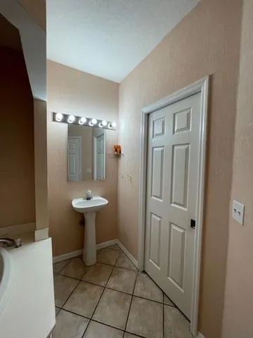 a bathroom with a sink a toilet and mirror