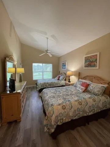 a bedroom with bed and wooden floor