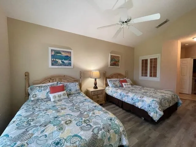 a bedroom with two bed and a chandelier