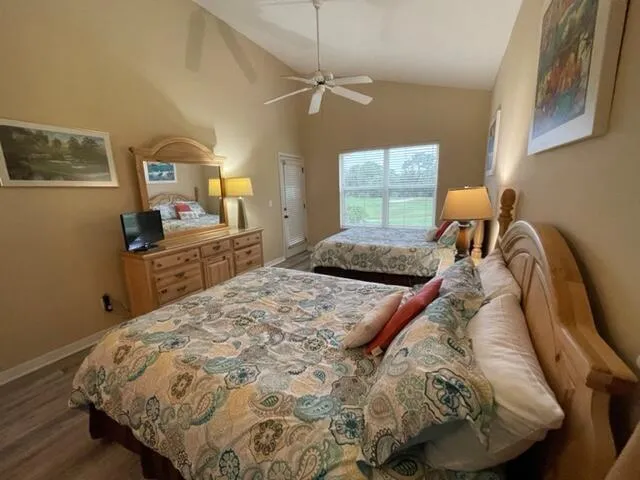 a bedroom with a bed and a dresser with mirror