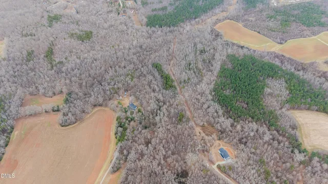 a view of a dry yard with wooden fence