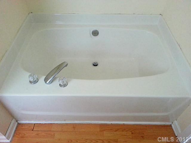 10546 Gold Pan Road Charlotte, NC 28215 - Photo 9 of 16 a bathroom with a bath tub