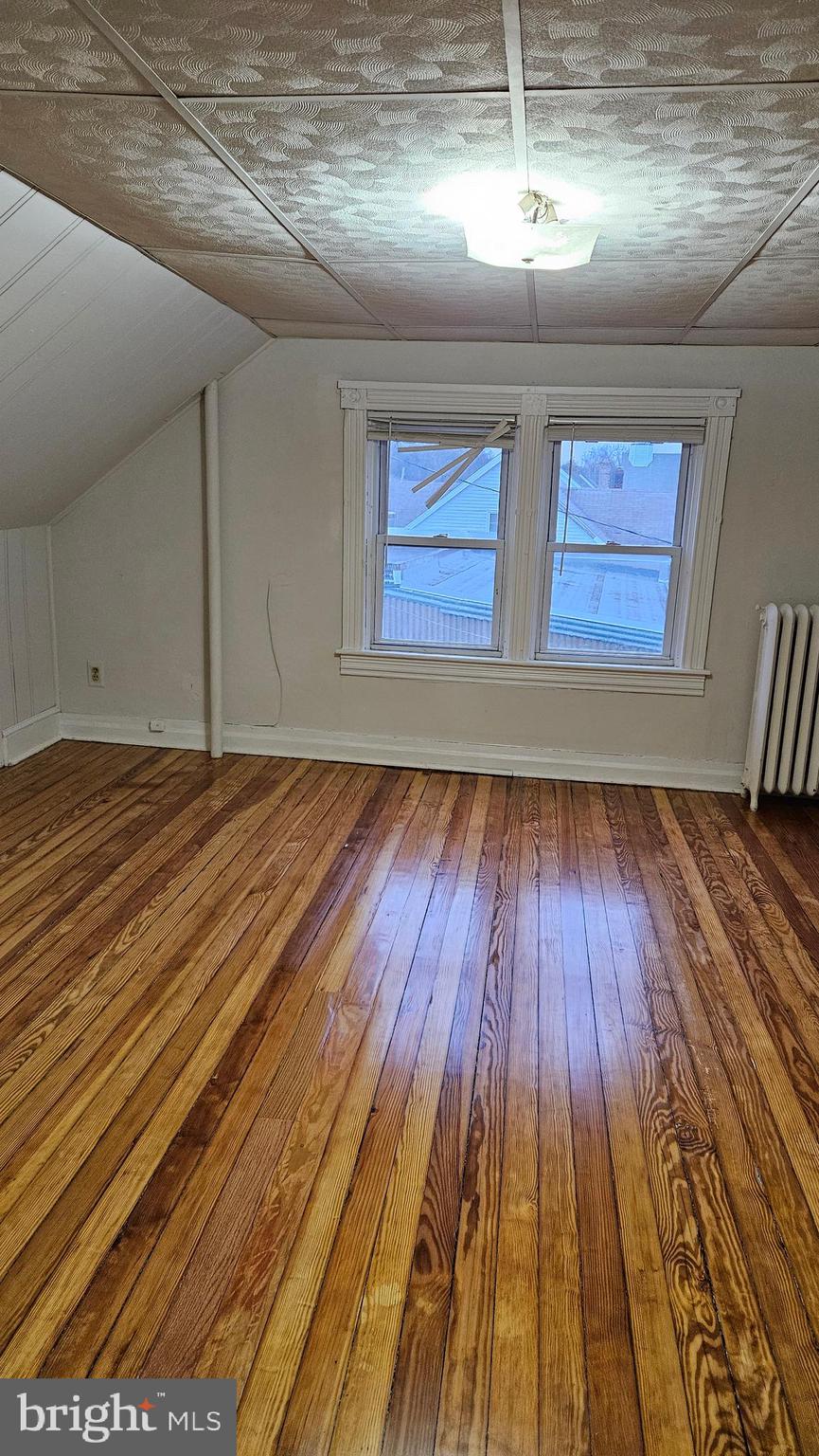 6330 Windsor Mill Road Gwynn Oak, MD 21207 - Photo 11 of 20 a view of empty room with wooden floor
