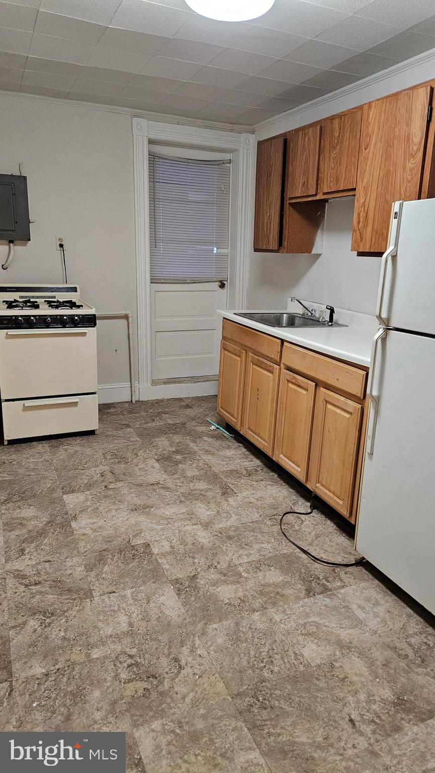 6330 Windsor Mill Road Gwynn Oak, MD 21207 - Photo 3 of 20 a kitchen with granite countertop a sink and a stove