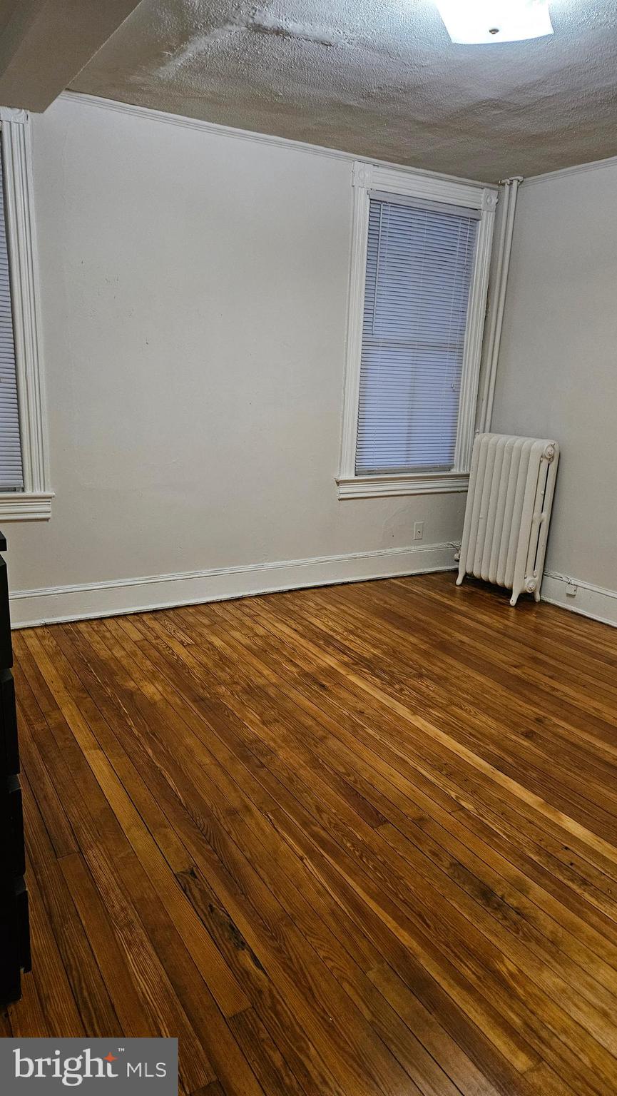 6330 Windsor Mill Road Gwynn Oak, MD 21207 - Photo 7 of 20 a view of wooden floor and brick walls