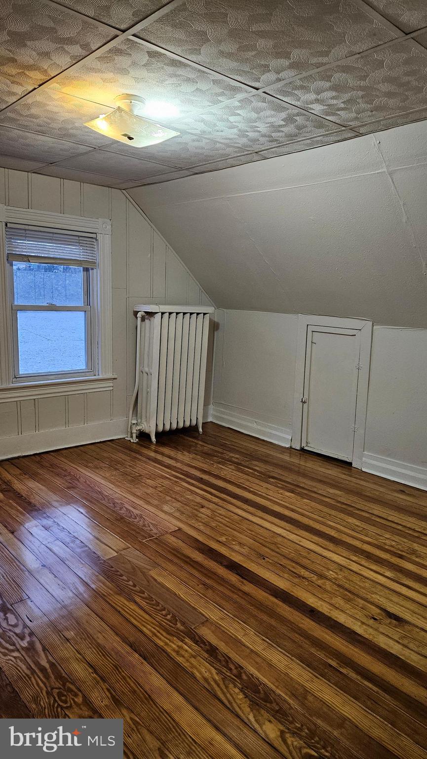6330 Windsor Mill Road Gwynn Oak, MD 21207 - Photo 9 of 20 a view of a room with wooden floor and window