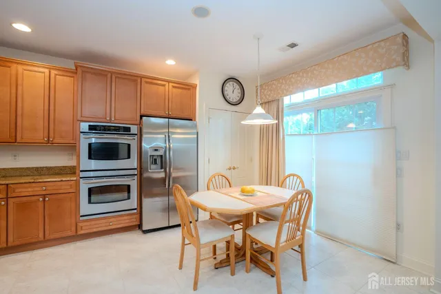 a kitchen with a table and chairs