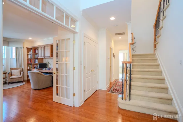 a view of entryway with wooden floor and living room