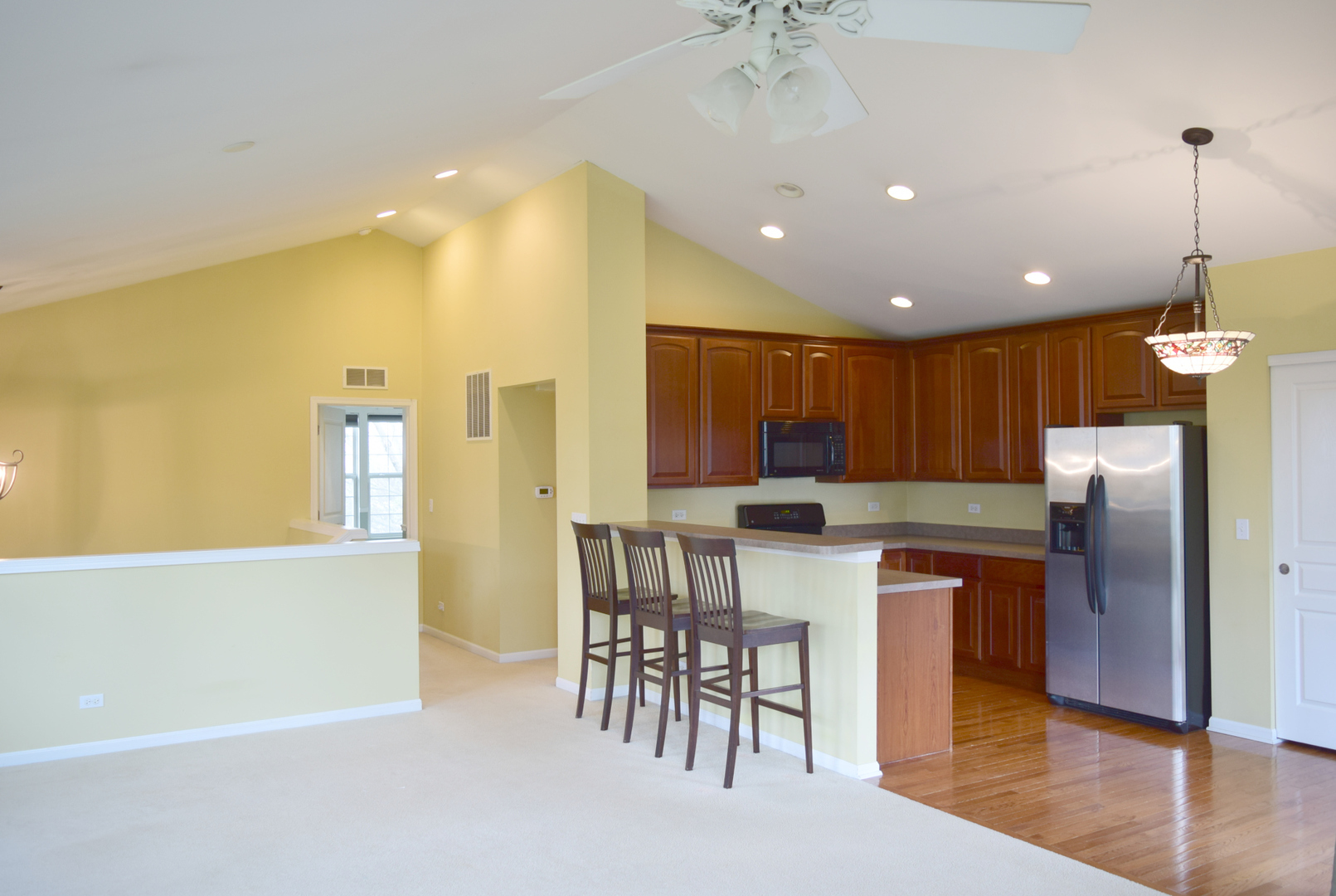 420 Valentine Way Oswego, IL 60543 - Photo 6 of 20 a kitchen with a table chairs refrigerator and cabinets