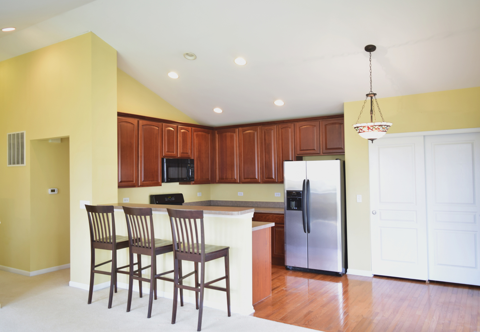 420 Valentine Way Oswego, IL 60543 - Photo 8 of 20 a kitchen with stainless steel appliances granite countertop a refrigerator a microwave a sink and a island