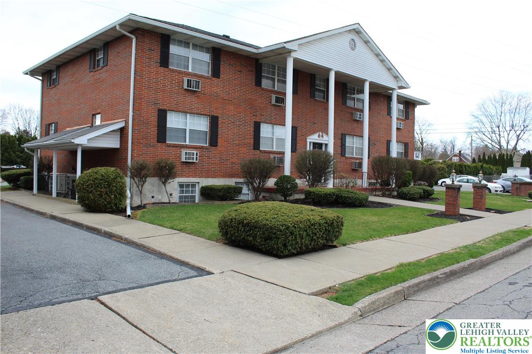 1204 Lewis Street, Unit BE Bethlehem, PA 18017 - Photo 2 of 13 a front view of a house with a yard and garage