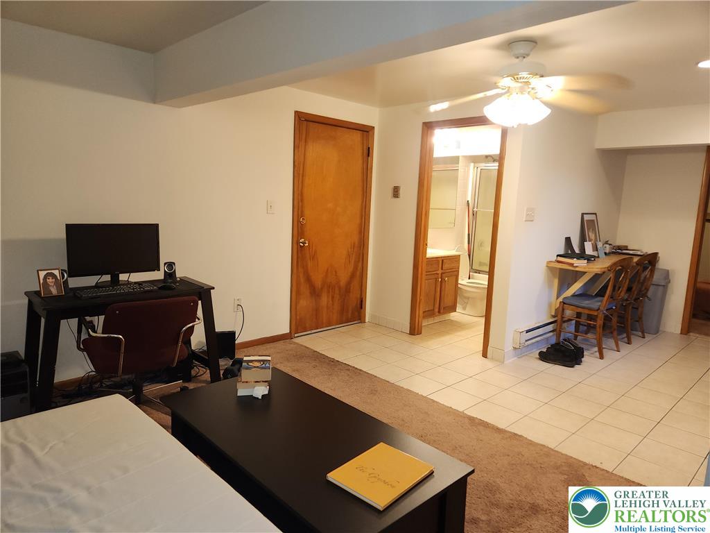 1204 Lewis Street, Unit BE Bethlehem, PA 18017 - Photo 4 of 13 a living room with furniture and a flat screen tv