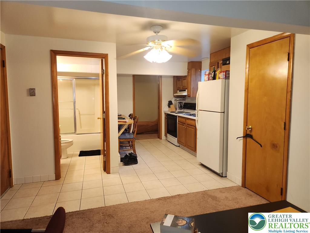 1204 Lewis Street, Unit BE Bethlehem, PA 18017 - Photo 6 of 13 a kitchen with a refrigerator a stove a washer and dryer