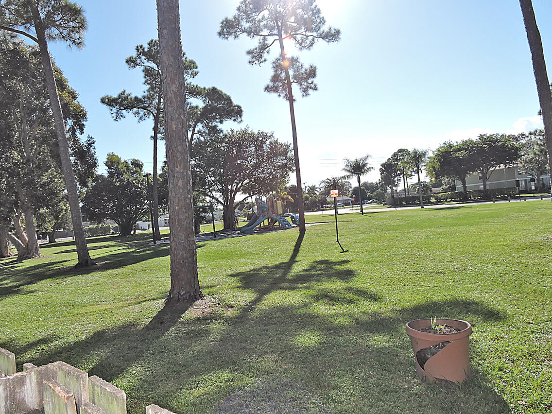 5040 Society Place East, Unit E West Palm Beach, FL 33415 - Photo 15 of 26 a view of a garden with a slide