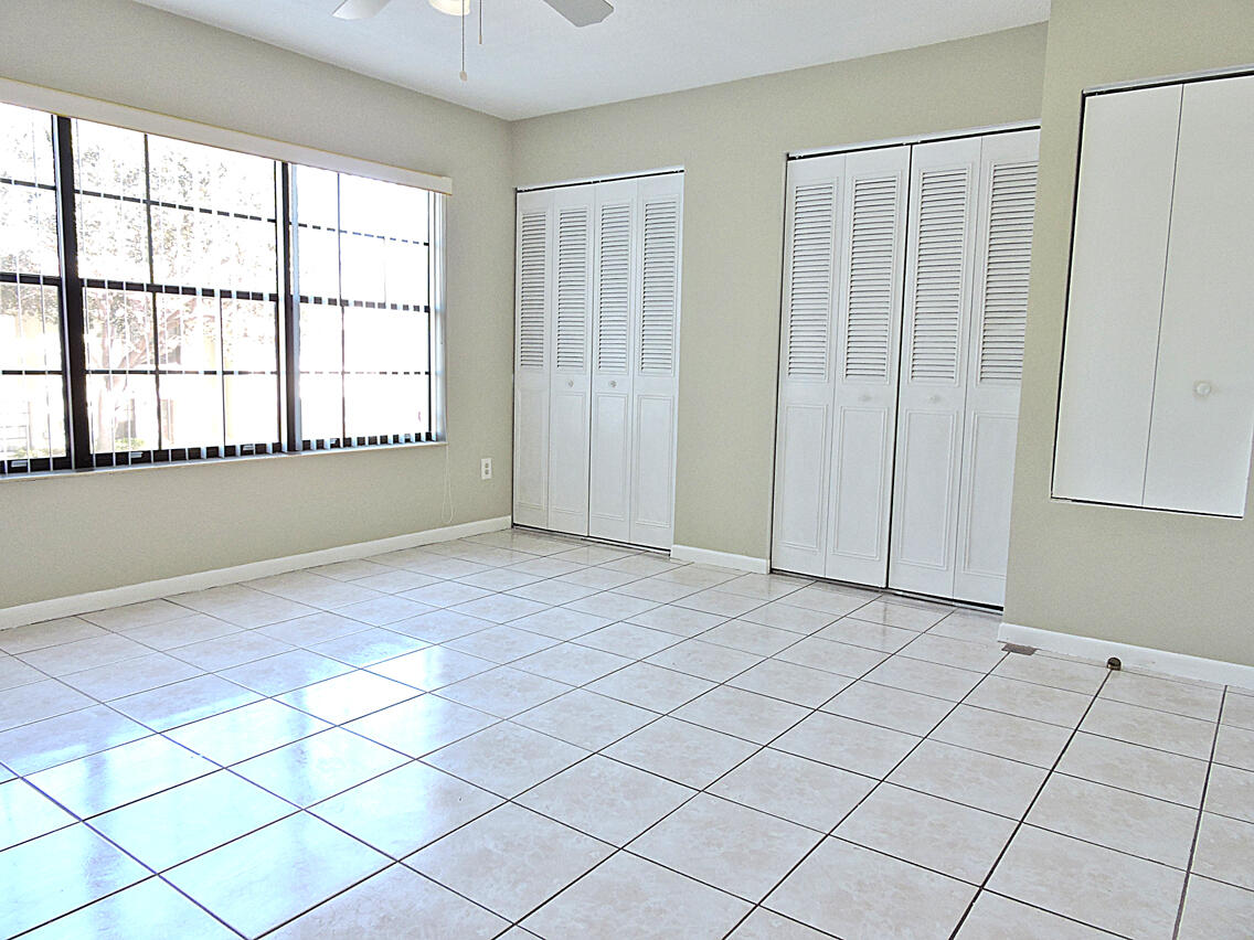 5040 Society Place East, Unit E West Palm Beach, FL 33415 - Photo 20 of 26 an empty room with windows