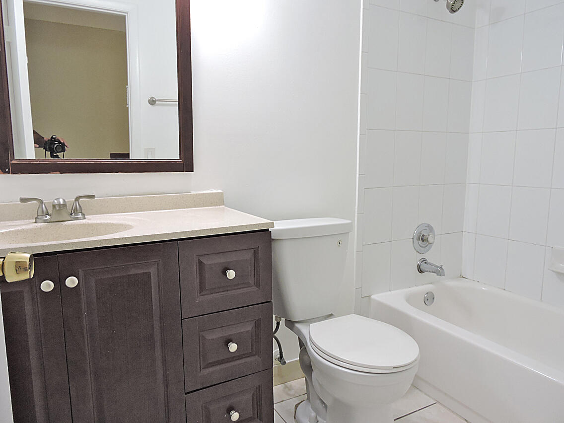 5040 Society Place East, Unit E West Palm Beach, FL 33415 - Photo 22 of 26 a bathroom with a sink and a toilet