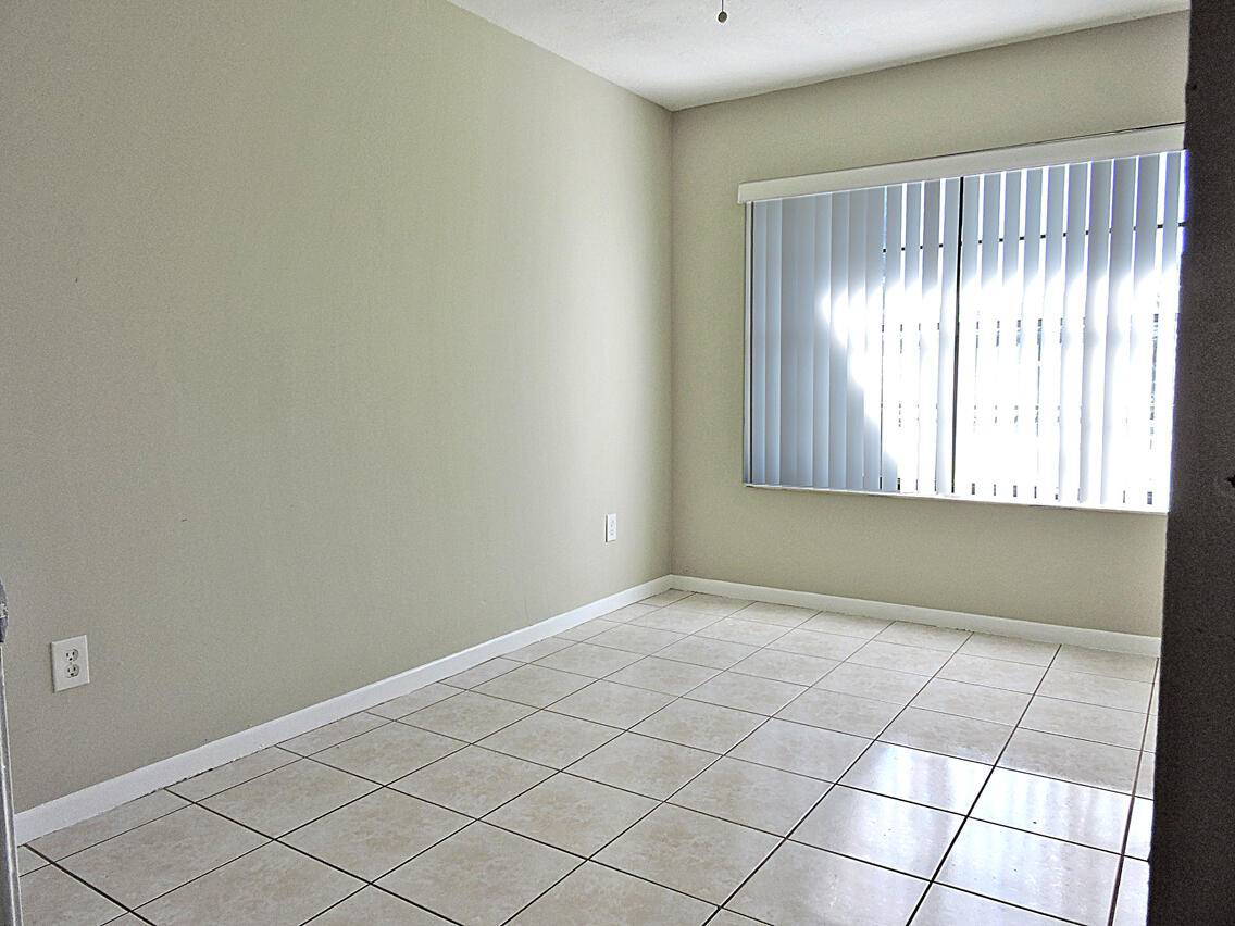 5040 Society Place East, Unit E West Palm Beach, FL 33415 - Photo 23 of 26 an empty room with windows
