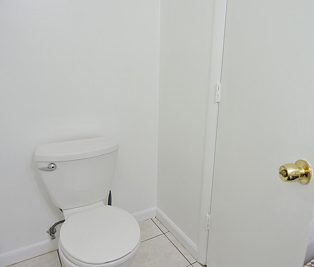 5040 Society Place East, Unit E West Palm Beach, FL 33415 - Photo 8 of 26 a white toilet sitting next to a white wall