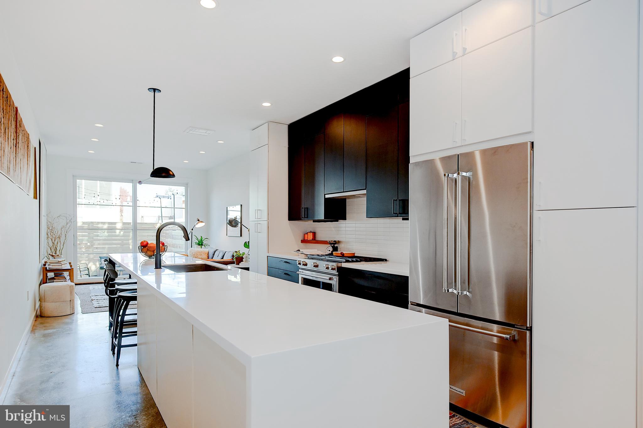 443 Ridge Street Northwest Washington, DC 20001 - Photo 12 of 47 a kitchen view with stainless steel appliances a refrigerator and a living room view