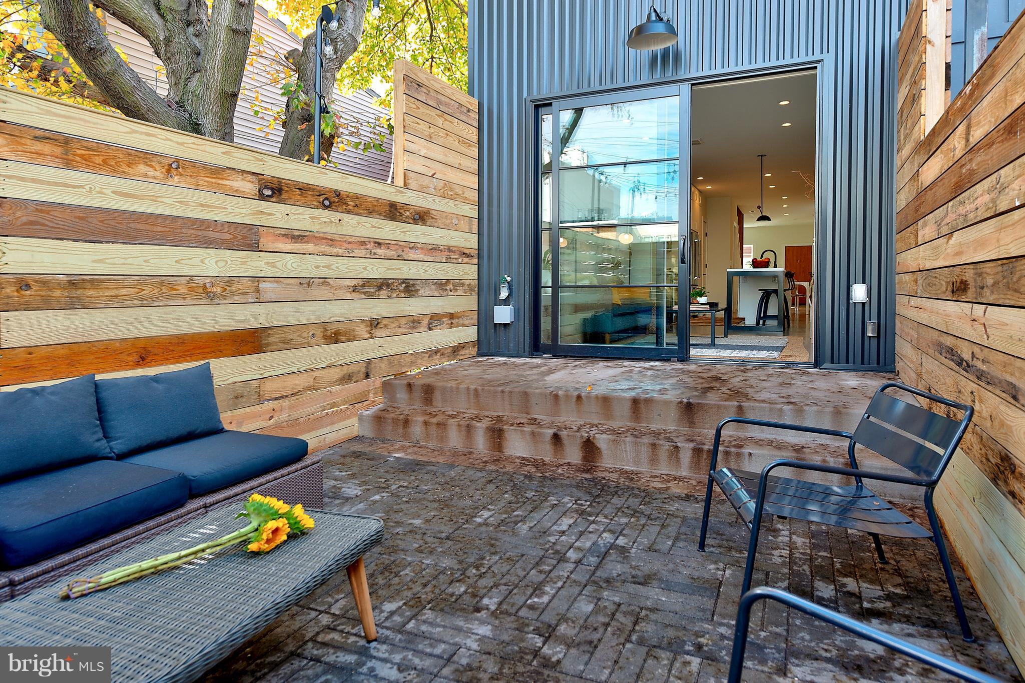 443 Ridge Street Northwest Washington, DC 20001 - Photo 20 of 47 a outdoor living space with patio furniture and a fireplace